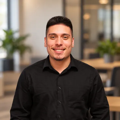 Tomas Cera, founder of KCV Strategic, smiling in a black shirt in a bright office.